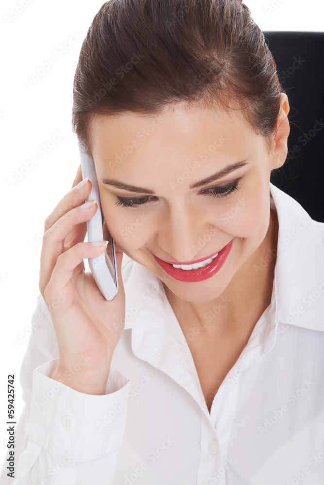 Young business woman with telephone, sitting by desk. Young business woman with telephone, sitting by desk.