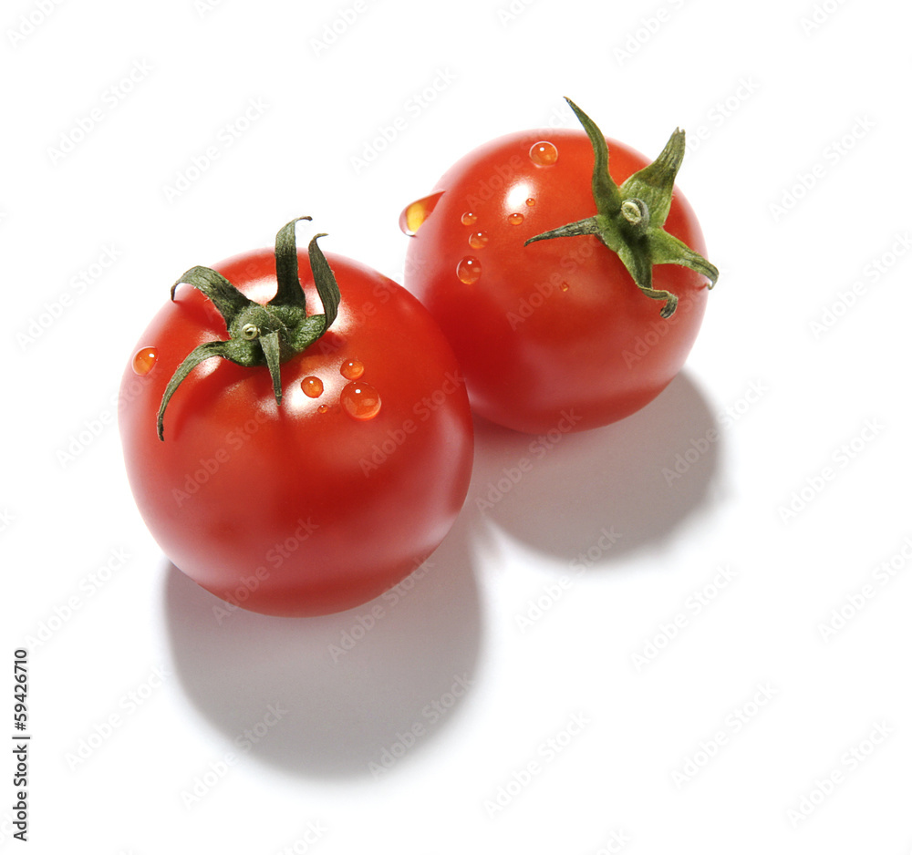 two red cherry tomatoes with water droplets on white background two red cherry tomatoes with water droplets on white background