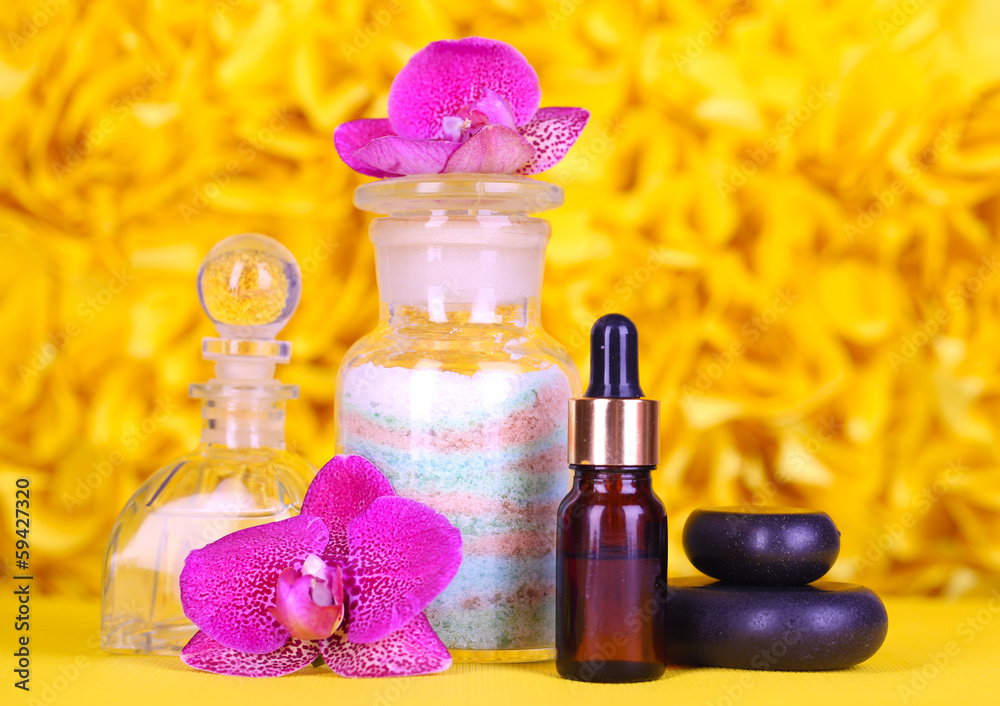 Beautiful spa setting with orchid on yellow background Beautiful spa setting with orchid on yellow background