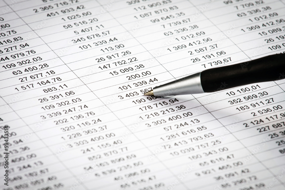 Businessman showing a diagram on a financial report using a pen Businessman showing a diagram on a financial report using a pen