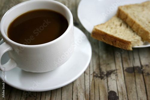 plate with a cup of coffee and bread