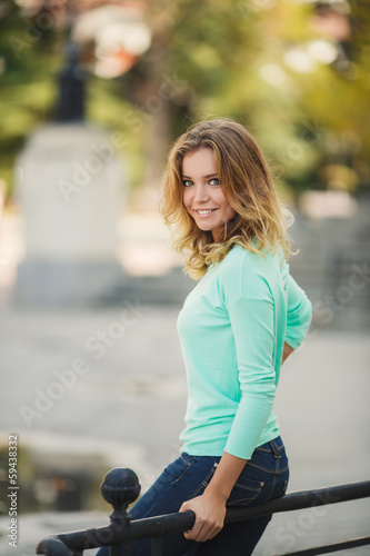 Portrait of a young beautiful smiling blonde woman outdoors © GTeam