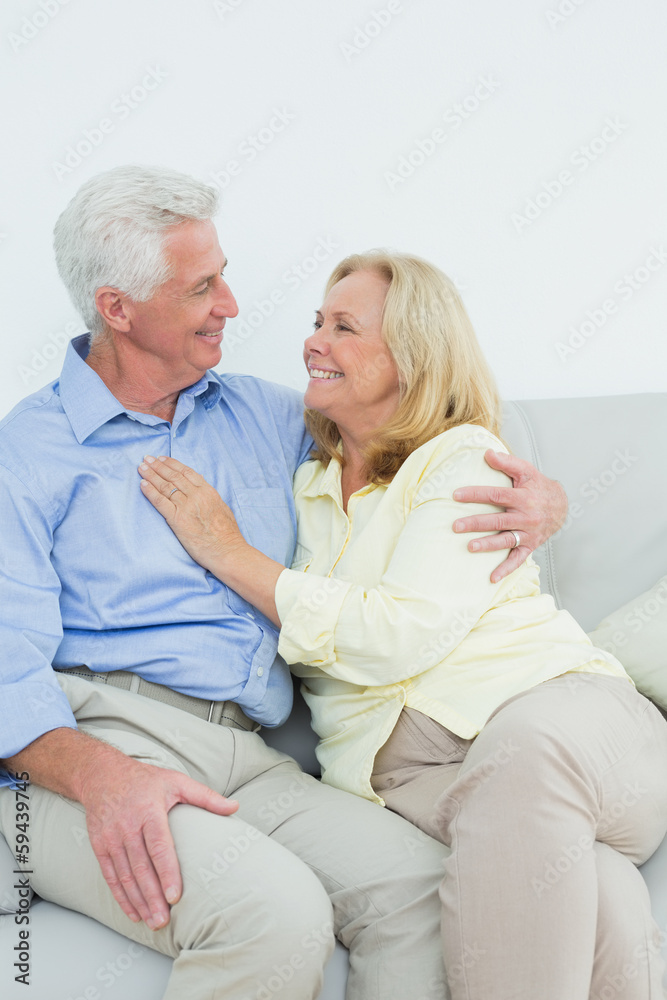 Happy romantic senior couple sitting on sofa Happy romantic senior couple sitting on sofa