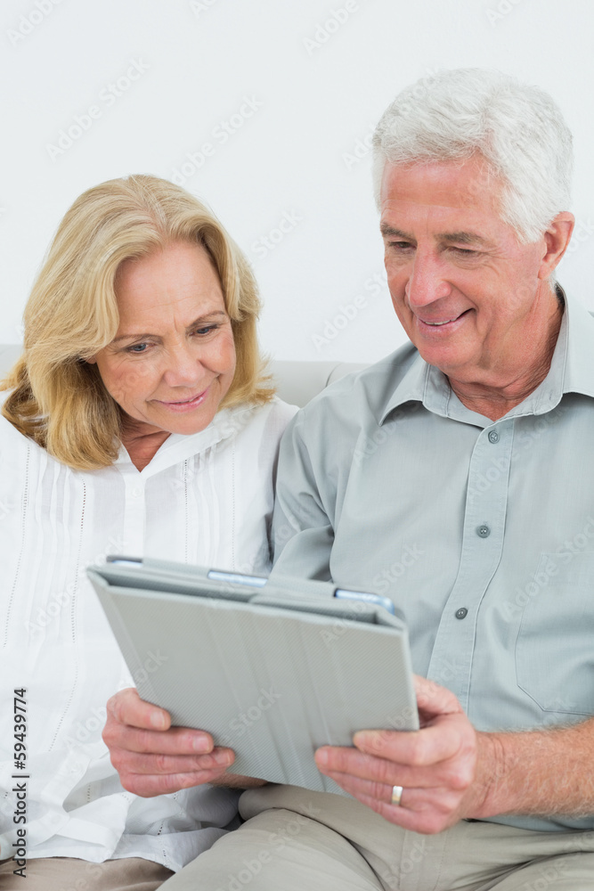 Relaxed happy senior couple using digital tablet Relaxed happy senior couple using digital tablet