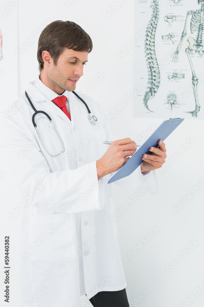 Doctor writing reports in the medical office Doctor writing reports in the medical office
