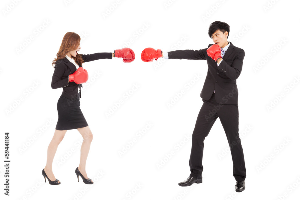 Business woman with boxing gloves having a fight with man
