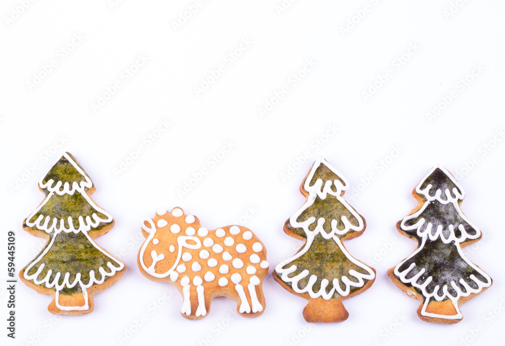 Gingerbread cookies and spices over white background close up