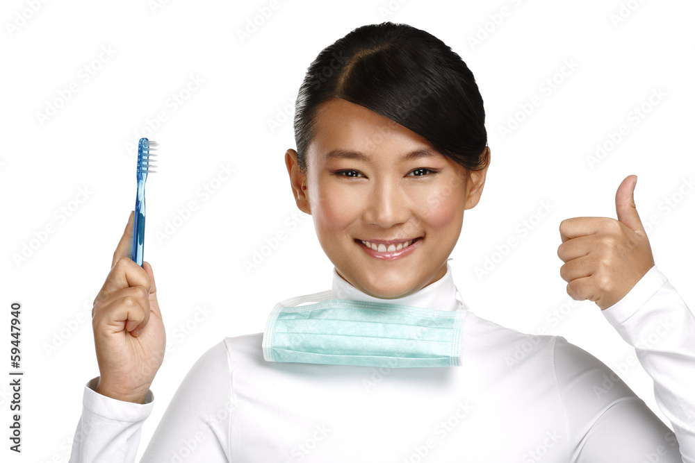 smiling young asian woman dentist showing a toothbrush smiling young asian woman dentist showing a toothbrush
