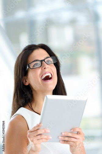 Happy woman holding digital tablet