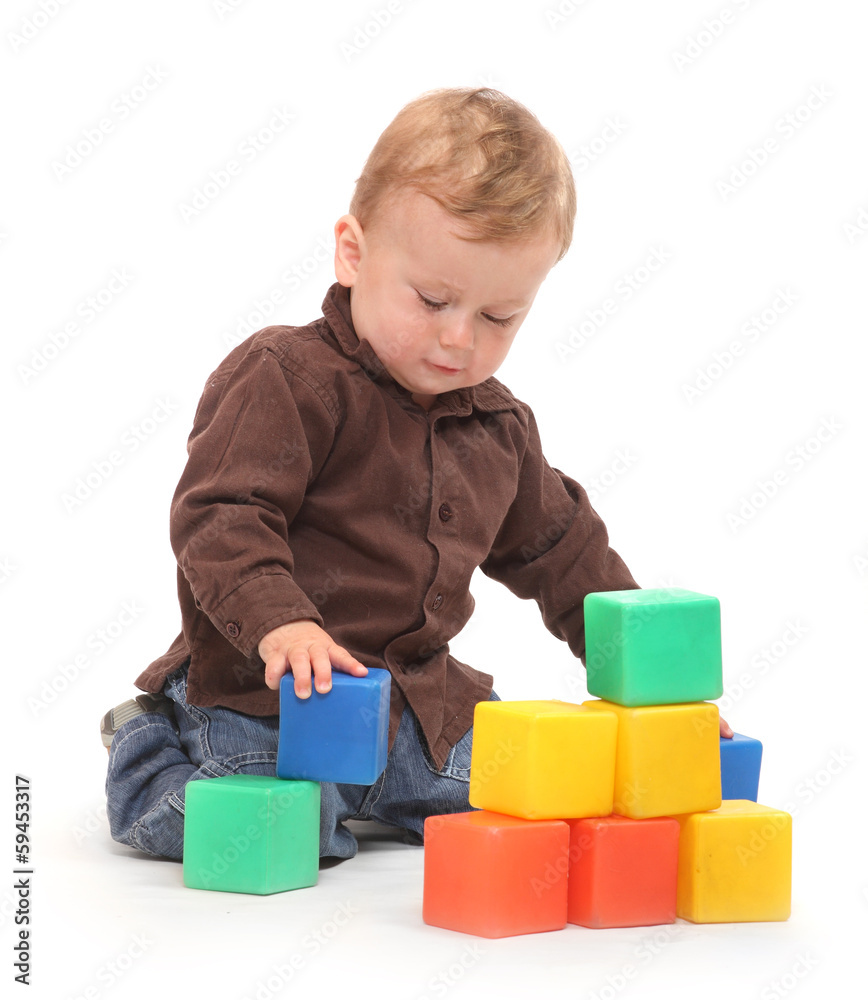 Little kid playing with toy blocks. Little kid playing with toy blocks.