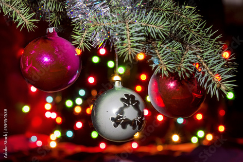 Slika na platnu Christmas balls on the tree against a backdrop of colourful brig