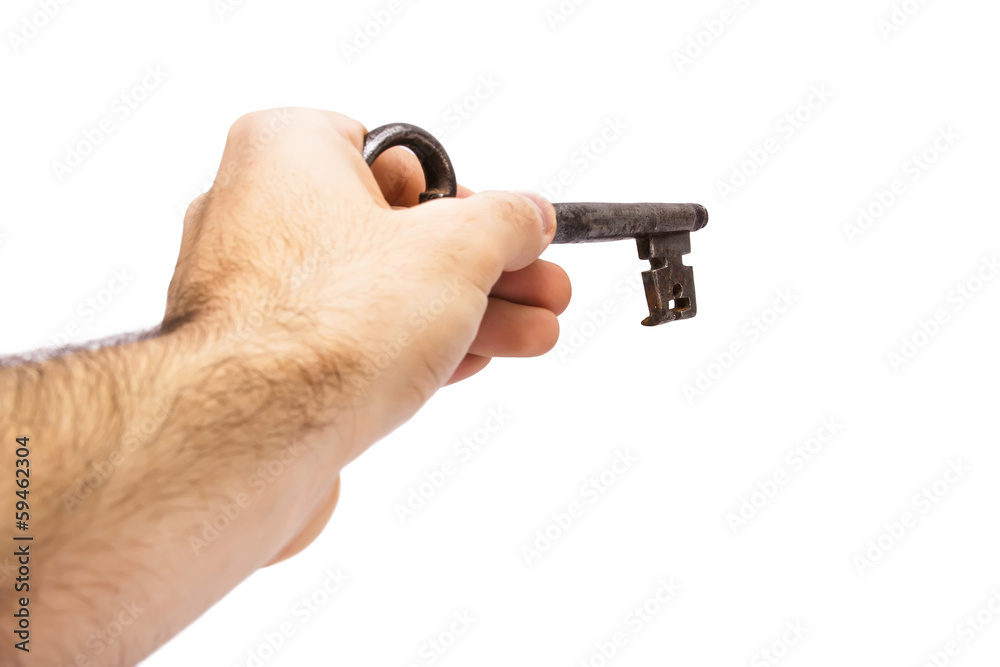 Old key in hand isolated on white background. Old key in hand isolated on white background.