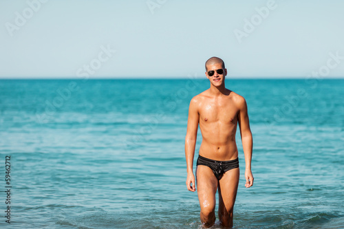 Portrait of men posing at the beach