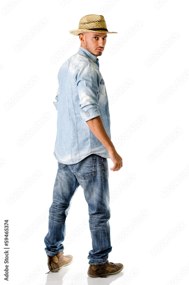 Trendy young man with jeans, denim shirt and straw hat Trendy young man with jeans, denim shirt and straw hat