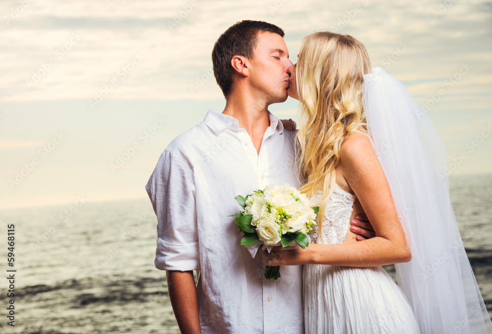 Bride and Groom, Romantic Newly Married Couple Kissing at the Be Bride and Groom, Romantic Newly Married Couple Kissing at the Be
