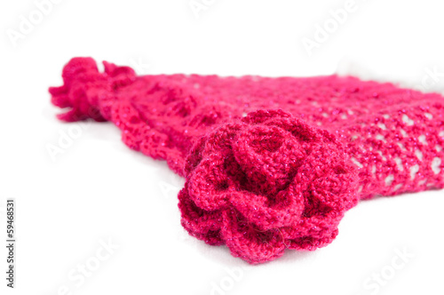 Red-white knitted hat with flowers on a white background