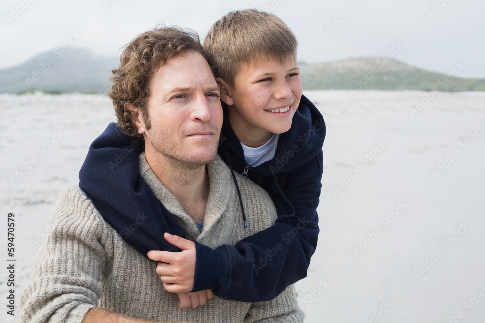 Fototapeta premium Casual man and son relaxing at beach