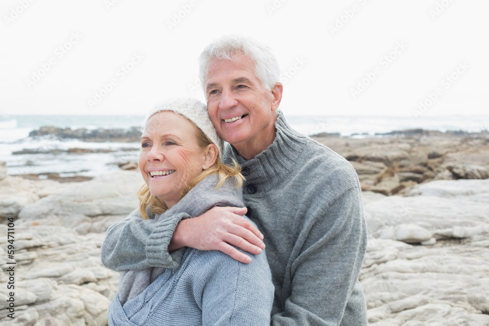 Romantic senior couple together on rocky beach