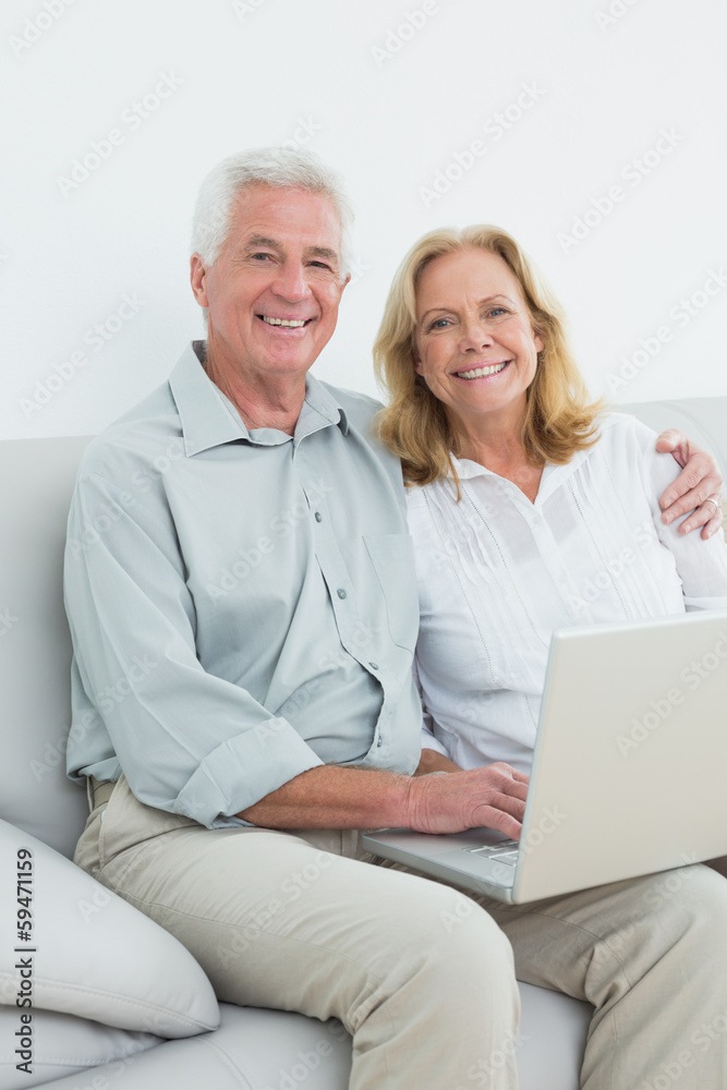 Portrait of a relaxed senior couple using laptop