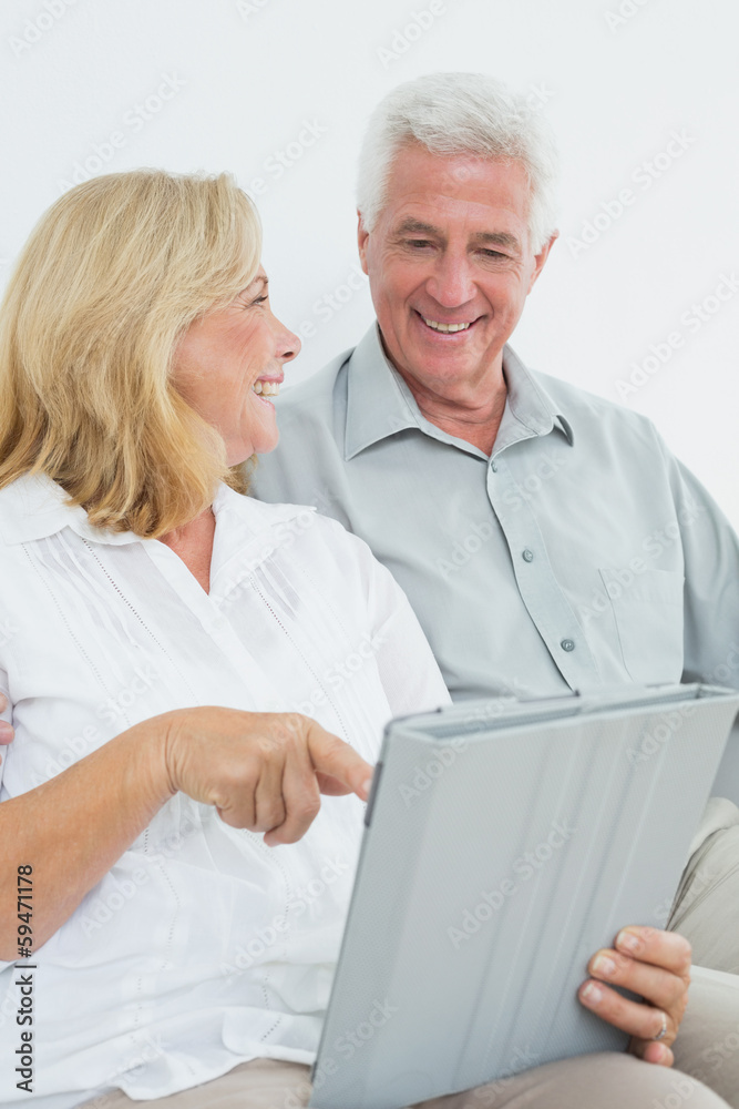 Relaxed senior couple using digital tablet at house Relaxed senior couple using digital tablet at house