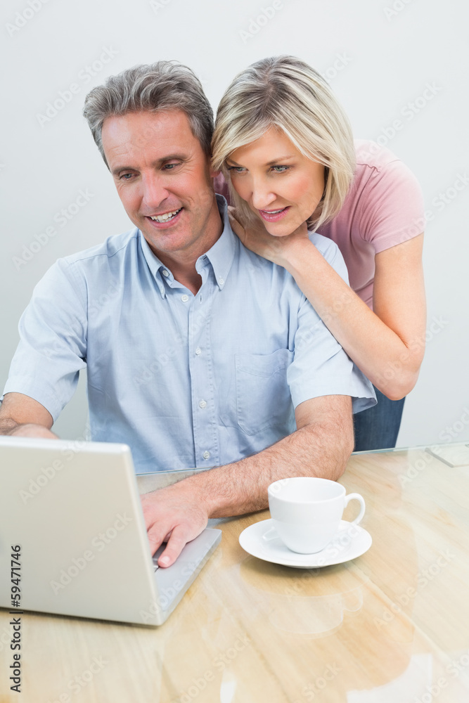 Concentrated content couple using laptop Concentrated content couple using laptop
