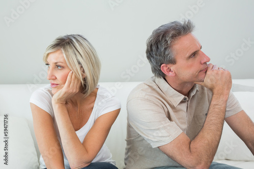 Relaxed couple sitting on sofa after a fight