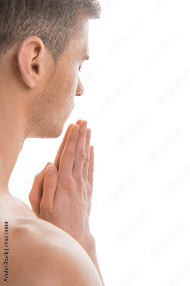 Fototapeta premium Portrait of undressed fit man praying.