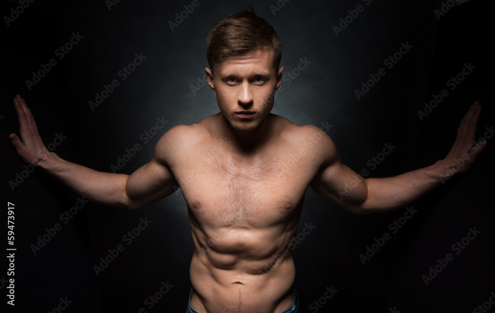 Sexy nude fit male model posing on camera.