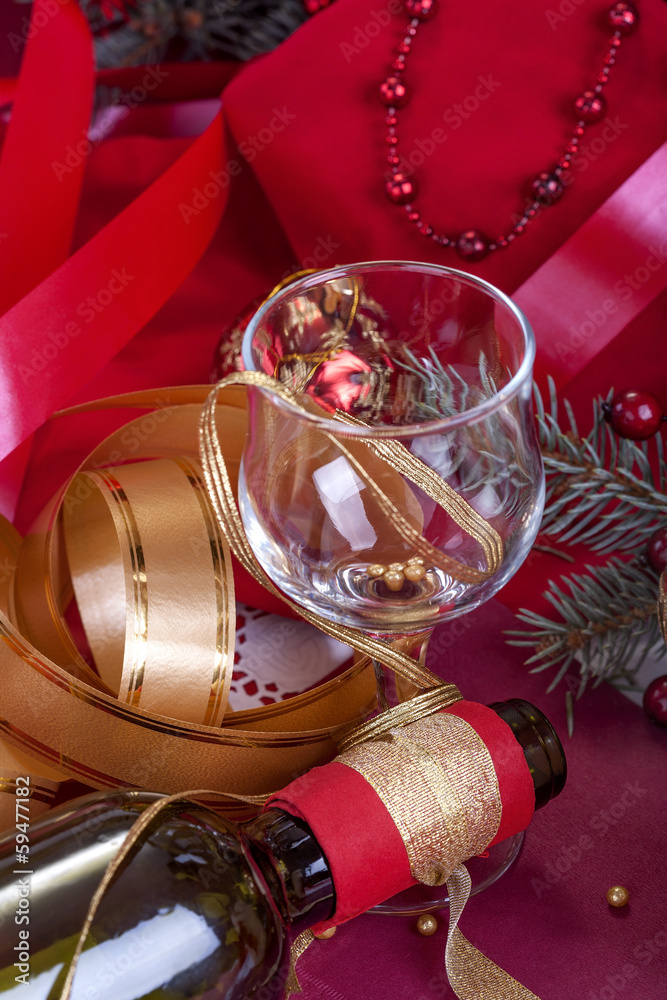 festively decorated glass and a bottle of wine festively decorated glass and a bottle of wine