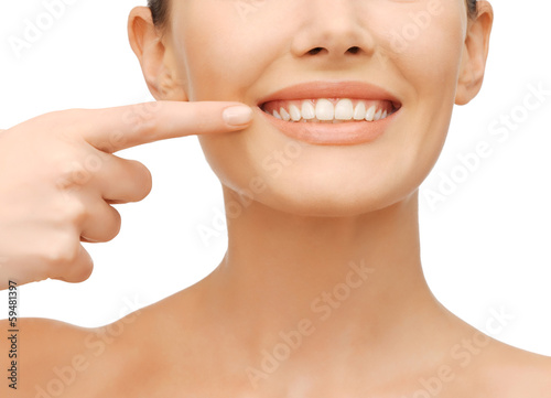 beautiful woman pointing to teeth