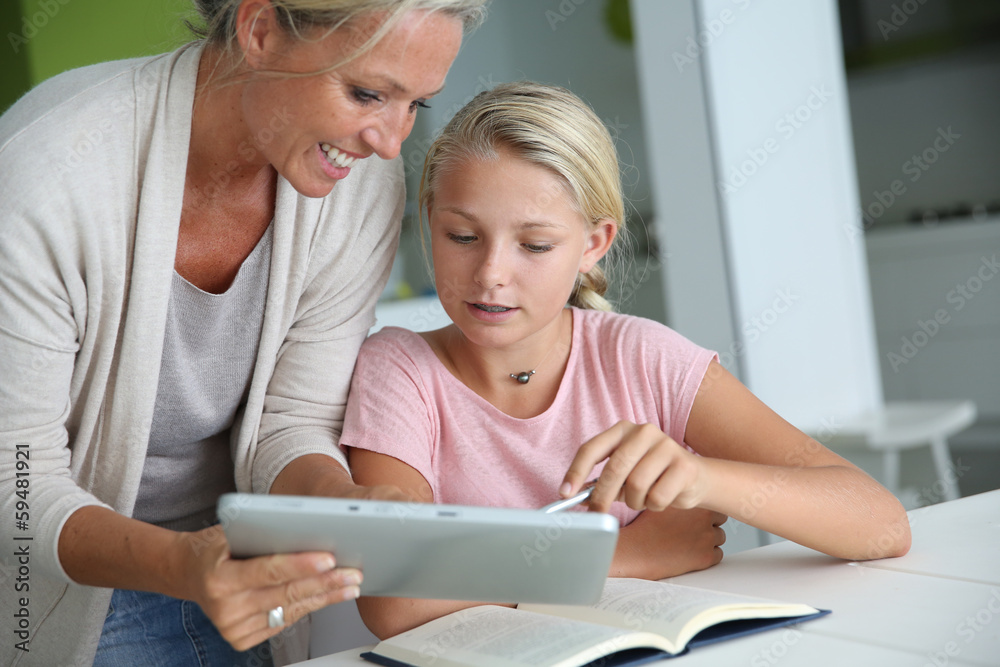 Mother helping girl with homework Mother helping girl with homework