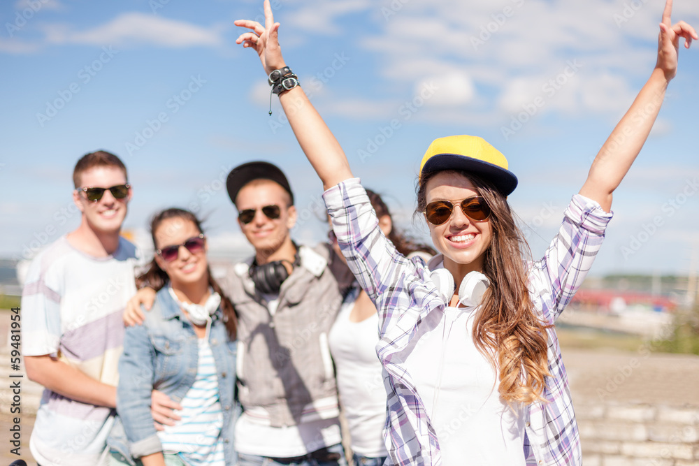 teenage girl with headphones and friends outside