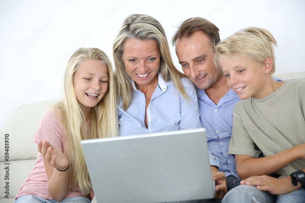 Family connected on internet with laptop