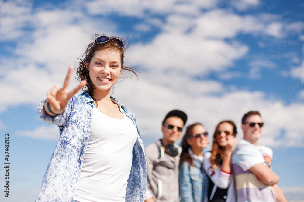 teenage girl with headphones and friends outside teenage girl with headphones and friends outside