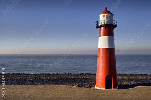 Red-white lighthouse on the coast of North Sea at Westkapelle