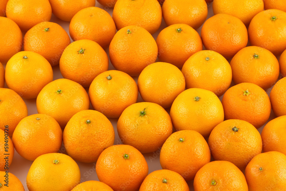 Fototapeta premium Many ripe orange tangerines as background closeup