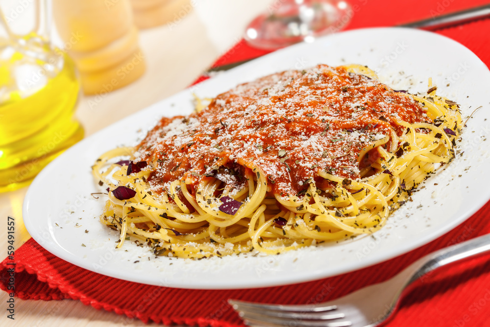 Pasta with sauce and parmesan cheese served on table Pasta with sauce and parmesan cheese served on table