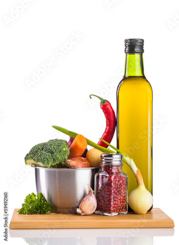 Fototapeta Naklejka Na Ścianę i Meble -  vegetables oil and stainless pot isolated on white