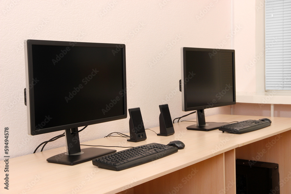 Computers on tables in room Computers on tables in room