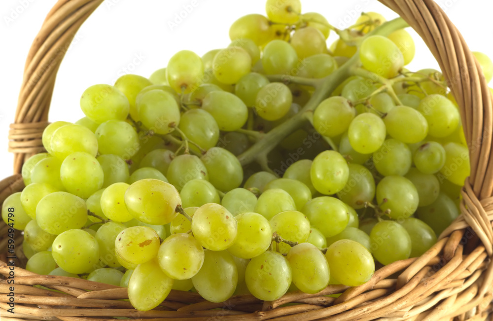 Bunches with green berries in brown wicker basket isolated Bunches with green berries in brown wicker basket isolated
