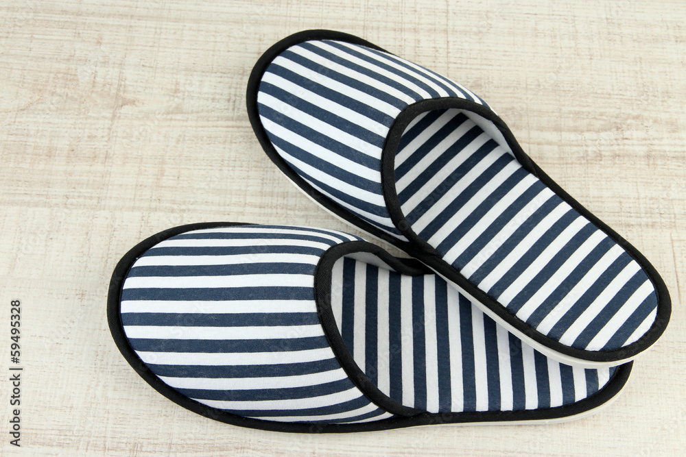 Striped slippers on wooden background Striped slippers on wooden background
