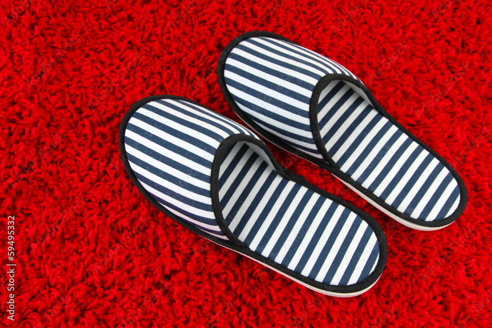 Striped slippers on carpet background Striped slippers on carpet background