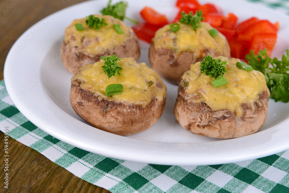 Stuffed mushrooms on plate on table close-up Stuffed mushrooms on plate on table close-up