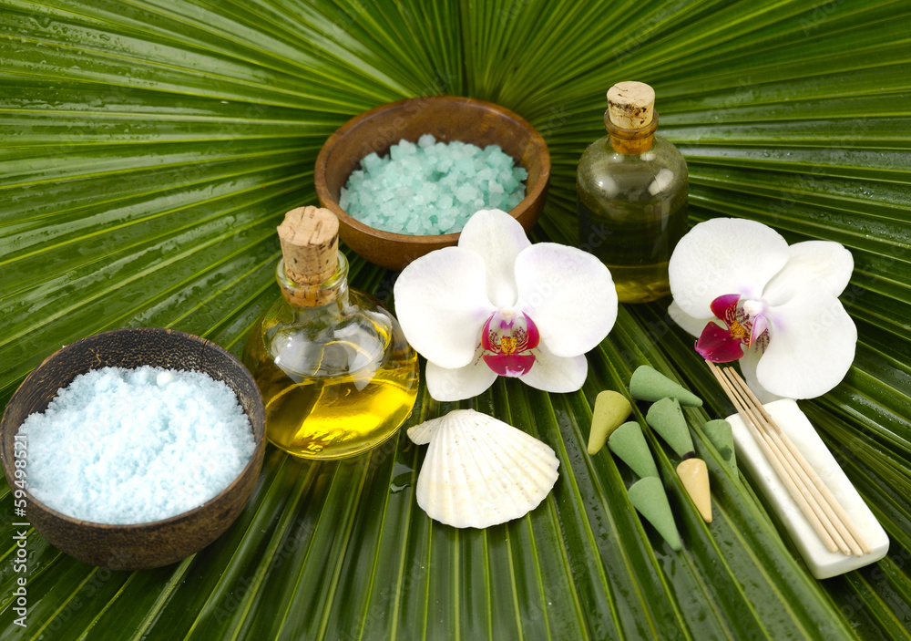 orchid with oil ,salt in bowl ,shell on palm leaf texture orchid with oil ,salt in bowl ,shell on palm leaf texture