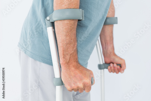 Close-up mid section of a man with crutches Fototapet