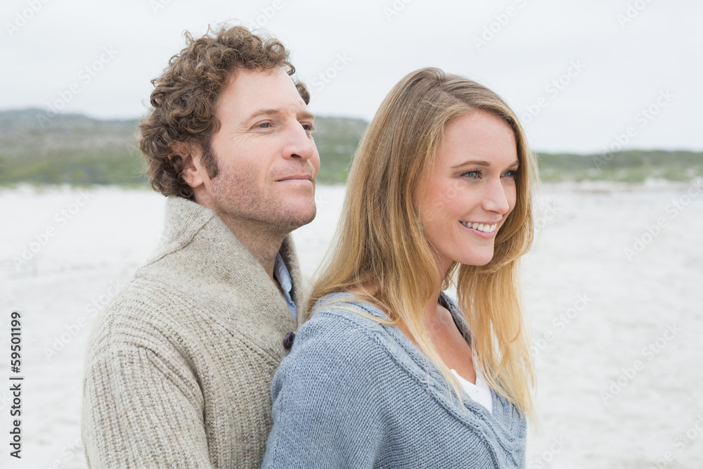 Side view of a relaxed young couple at beach Side view of a relaxed young couple at beach