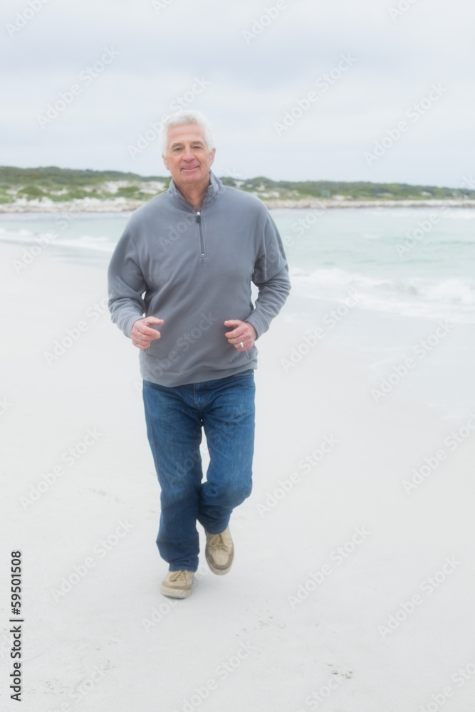 Full length of a senior man running at beach Full length of a senior man running at beach