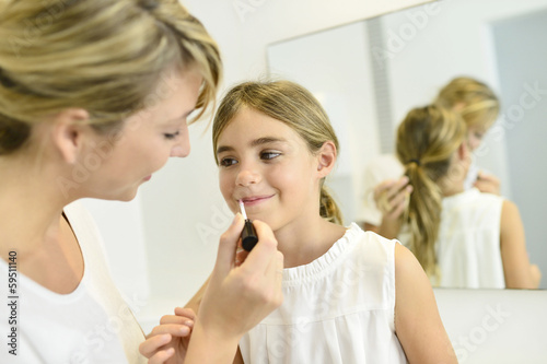 Little girl playing with her mom s makeup