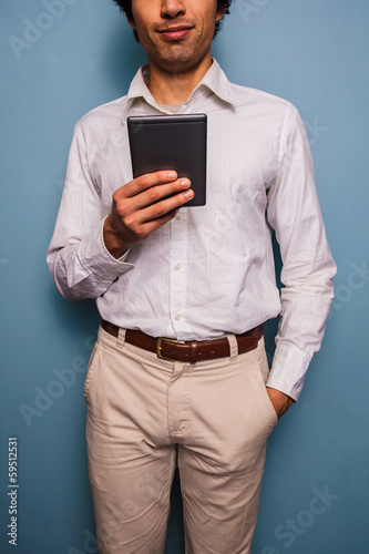 Young man reading on a digital tablet