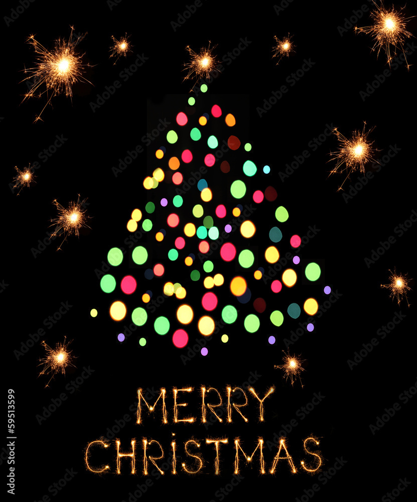 Christmas tree-shaped sparklers on black background Christmas tree-shaped sparklers on black background